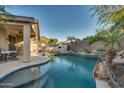 Relaxing backyard with a large pool and patio area at 6233 W Maya Dr, Phoenix, AZ 85083