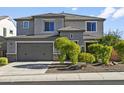 Two-story house with gray siding, landscaping, and a two-car garage at 7180 W Tombstone Trl, Peoria, AZ 85383