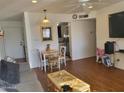 Living room with wood floors, dining area, and kitchen view at 720 N 82Nd St # E210, Scottsdale, AZ 85257