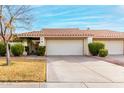 Front view of a tan stucco house with a tile roof and a two-car garage at 7373 S Bonarden Ln, Tempe, AZ 85283