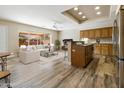 Open concept kitchen and living area with wood cabinets and tile floors at 8309 E Navarro Ave, Mesa, AZ 85209