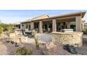 Covered patio with built-in BBQ and seating area, surrounded by desert landscaping at 9321 E Diamond Dr, Sun Lakes, AZ 85248