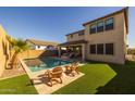 Inviting backyard with a refreshing pool and ample lawn space at 9846 E Resistance Ave, Mesa, AZ 85212