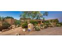 Beautiful desert landscape surrounds this single-story home at 9901 E Hidden Valley Rd, Scottsdale, AZ 85262