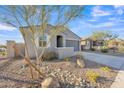 Single-story home with landscaped front yard and attached garage at 11026 S 55Th Ln, Laveen, AZ 85339