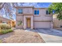 Exterior shot of a two-story home featuring a two-car garage and desert landscaping at 1259 E Canyon Trl, San Tan Valley, AZ 85143