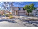 Street view of a two-story home with well-maintained landscaping and clear blue skies at 1259 E Canyon Trl, San Tan Valley, AZ 85143