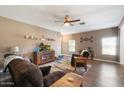 Living room with ample natural light and a ceiling fan at 15325 W Port Au Prince Ln, Surprise, AZ 85379