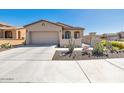 House exterior showcasing a garage and drought-tolerant landscaping at 16789 S 181St Ln, Goodyear, AZ 85338