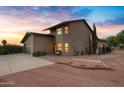 Beautiful home exterior with a landscaped yard and sunset view at 17642 E Hunt Hwy, Queen Creek, AZ 85142