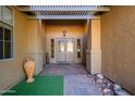 Elegant entryway with a covered patio and a double door at 17721 N Canal Dr, Surprise, AZ 85374