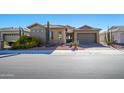 Single-story home with desert landscaping and a two-car garage at 17721 N Canal Dr, Surprise, AZ 85374