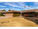 Brick home with covered patio and well-maintained lawn at 17811 N Boswell Blvd, Sun City, AZ 85373