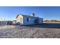 Side view of a single-story house with a car parked in the driveway at 1826 S 363Rd Ave, Tonopah, AZ 85354