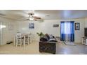 Living room features a gray couch and a small dining area at 1826 S 363Rd Ave, Tonopah, AZ 85354