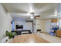 Open living and kitchen area with dining table and a gray couch at 1826 S 363Rd Ave, Tonopah, AZ 85354