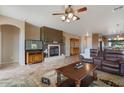 Spacious living room featuring a fireplace and leather furniture at 18311 E San Ignacio Ct, Gold Canyon, AZ 85118