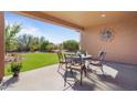 Covered patio with seating area overlooking a grassy backyard at 18311 E San Ignacio Ct, Gold Canyon, AZ 85118