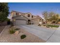 Two-story house with gray exterior, landscaped yard, and a three-car garage at 1918 W Bonanza Ln, Phoenix, AZ 85085