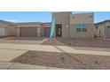 Modern home showcasing a three-car garage, desert landscaping, and a 'Ready Now' sign at 22663 E Happy Rd, Queen Creek, AZ 85142