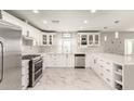 Modern white kitchen with stainless steel appliances at 2317 W Danbury Rd, Phoenix, AZ 85023