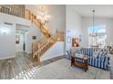 Two-story living room with hardwood floors, staircase, and high ceilings at 23619 N 21St St, Phoenix, AZ 85024