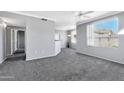 Spacious living room featuring gray carpeting and large window at 29606 N Tatum Blvd # 216, Cave Creek, AZ 85331