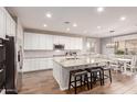 Modern kitchen featuring white cabinets, granite countertops, and an island at 30255 N 115Th Dr, Peoria, AZ 85383