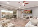 Spacious living room with tile floors, fireplace, and sliding glass doors at 30255 N 115Th Dr, Peoria, AZ 85383