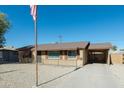 Charming Ranch style home with American flag and driveway at 3750 W Marshall Ave, Phoenix, AZ 85019