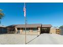 Ranch style home with carport and landscaped front yard at 3750 W Marshall Ave, Phoenix, AZ 85019