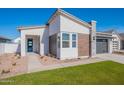 Beautiful home exterior with a blue door, modern design, and well-maintained lawn at 3752 W Antelope Way, San Tan Valley, AZ 85144