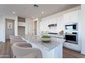 Bright, modern kitchen with stainless steel appliances and a large marble island at 3752 W Antelope Way, San Tan Valley, AZ 85144