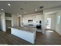 Modern kitchen with white cabinets, granite countertops, and a breakfast bar at 3752 W Antelope Way, San Tan Valley, AZ 85144