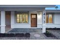 Attractive front door entry with updated landscaping and a modern light fixture at 413 W Marco Polo Rd, Phoenix, AZ 85027