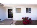 Black front door with glass block window and red flowers at 4525 N 82Nd St, Scottsdale, AZ 85251