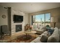 Bright living room featuring a fireplace and ample natural light at 4805 N Woodmere Fairway Ln # 1012, Scottsdale, AZ 85251