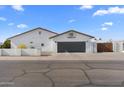 White single story home with a large garage and basketball hoop at 500 W Jasper Dr, Chandler, AZ 85225