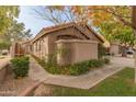 Front view of a tan house with a walkway and landscaping at 5025 E Waltann Ln, Scottsdale, AZ 85254