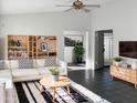 Spacious living room with L-shaped sofa and built-in shelving at 5036 W Gelding Dr, Glendale, AZ 85306