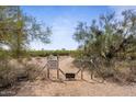 Trail access gate with a warning sign at 5271 E Shiprock St, Apache Junction, AZ 85119