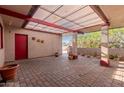 Covered patio with brick pavers and potted plants at 5715 W Heatherbrae Dr, Phoenix, AZ 85031