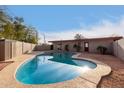 Kidney shaped swimming pool in backyard at 5715 W Heatherbrae Dr, Phoenix, AZ 85031