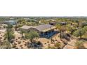 Aerial view of house with covered patio, desert landscaping, and mountain backdrop at 5950 E Lowden Ct, Cave Creek, AZ 85331