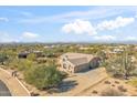 Aerial view of single-story house with a large backyard and desert landscaping at 5950 E Lowden Ct, Cave Creek, AZ 85331