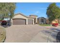 Two-car garage and front yard with landscaping at 6406 E Helm Dr, Scottsdale, AZ 85254