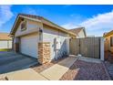 Attached garage with stone accents and a side gate at 731 N Nantucket St, Chandler, AZ 85225