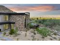 View of the home's stone exterior with mountain views at 8200 N Charles Dr, Paradise Valley, AZ 85253