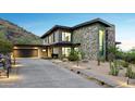 Contemporary home with stone facade and attached garage at 8200 N Charles Dr, Paradise Valley, AZ 85253