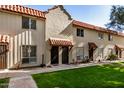 Two-unit Spanish-style building with tile roofs and a manicured lawn at 8241 N Central Ave # 32, Phoenix, AZ 85020